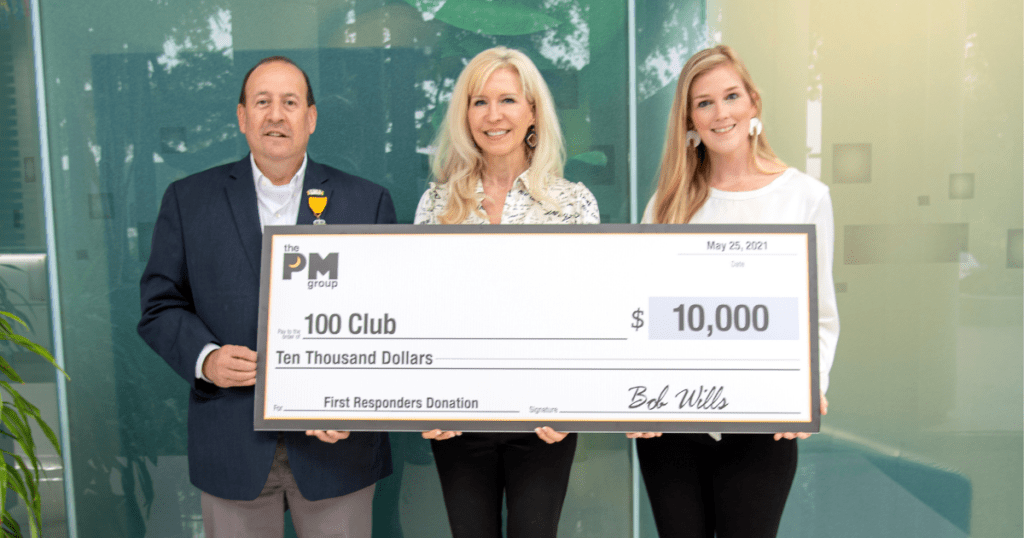 An image of The PM Group President Fran Yanity presenting a $10000 to the 100 Club