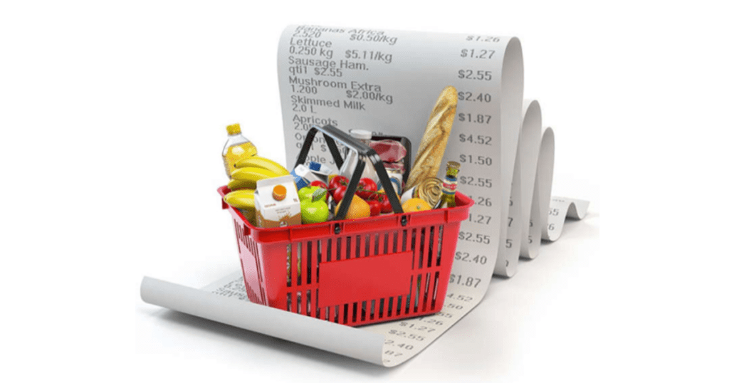 An image of a red shopping basket with produce and a big receipt behind it